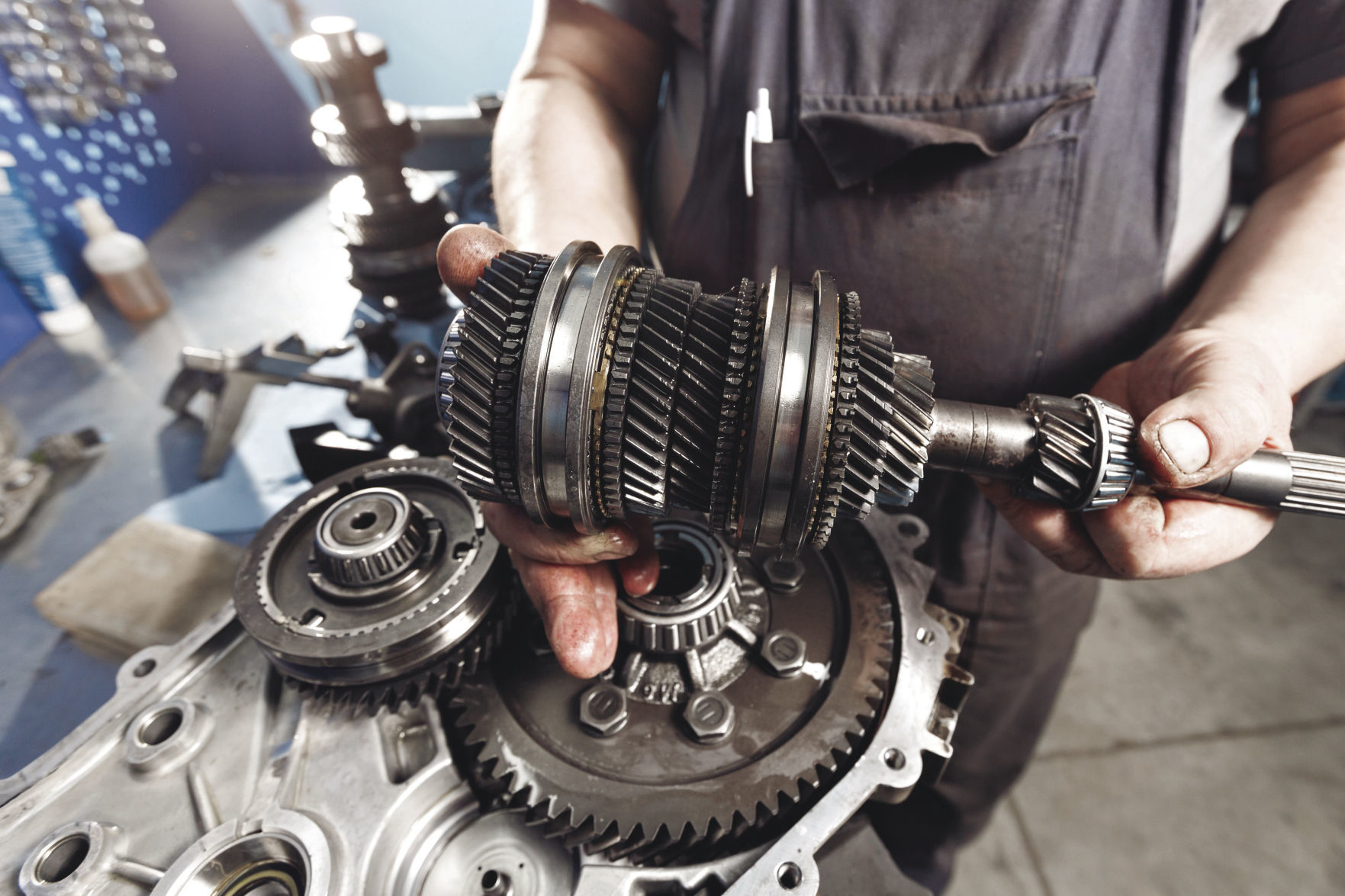 Cross-section of a car gearbox. mechanics work in the garage. hand mechanic in working clothes